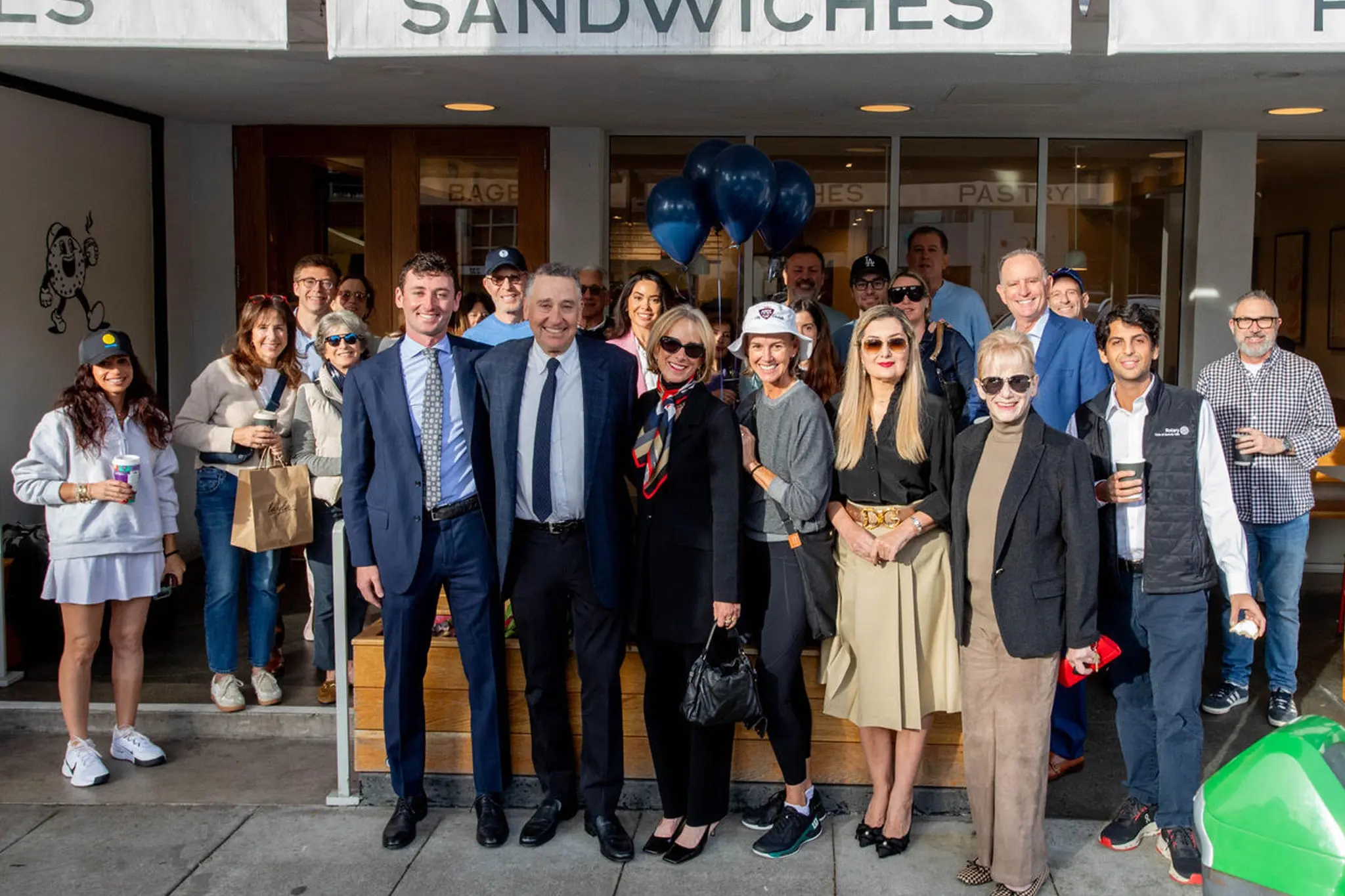 Andy Licht stands with his wife, Lisa, and their son, Joey, as supporters gather outside Layla’s Bagels in Beverly Hills during his petition signing event marking the start of his City Council campaign.