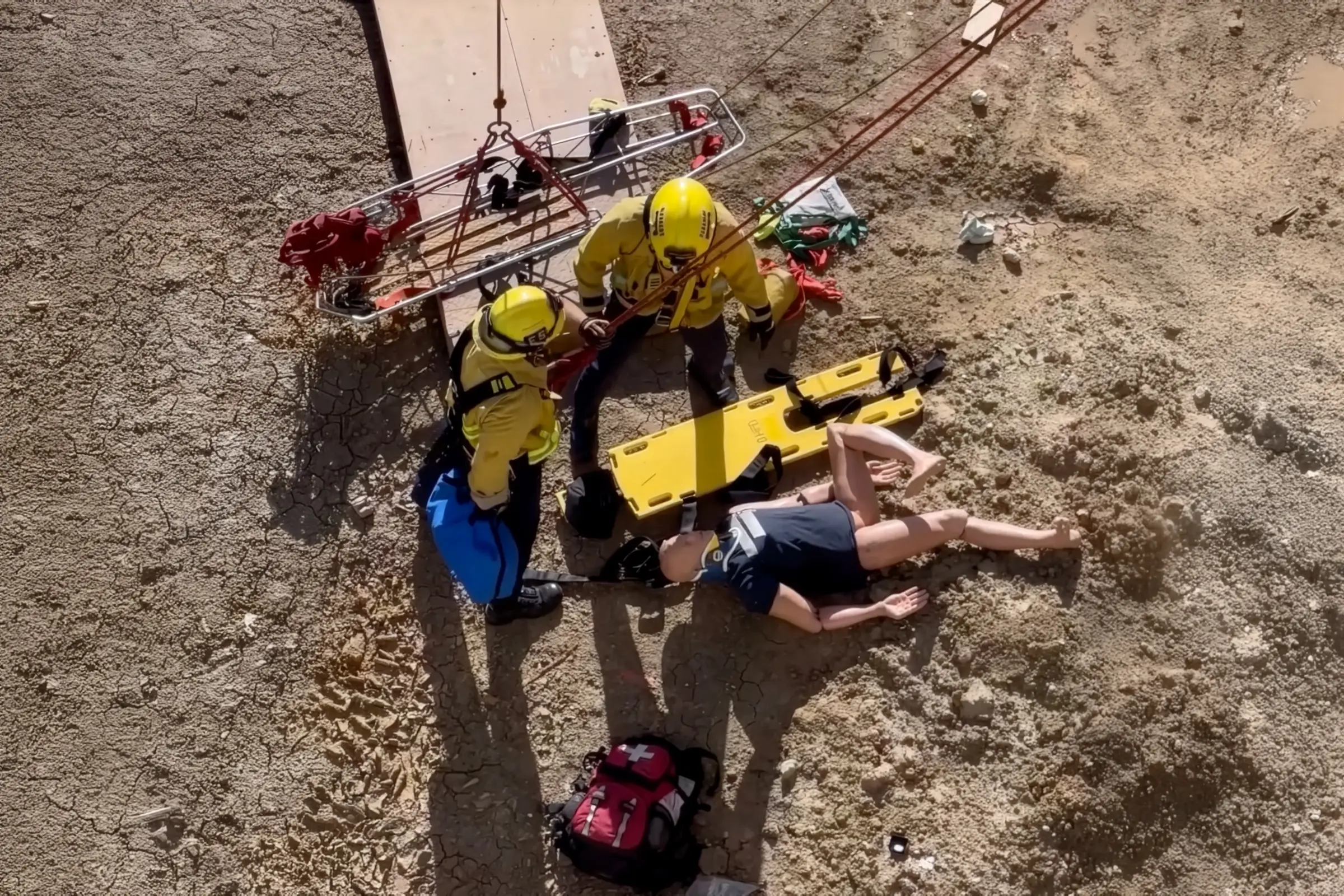 Beverly Hills Fire Department firefighters simulate a technical rescue scenario using rope systems and a stokes basket during a training drill at Beverly Hills High School.