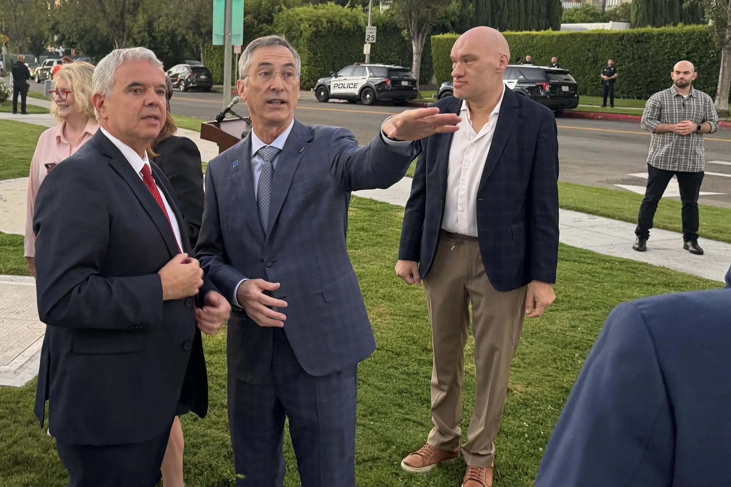 Beverly Hills Mayor Craig Corman points toward the planned October 7 memorial site across the street, alongside Israeli Consul General Modi Ephraim, during the city's October 7 Moment of Remembrance at Rexford Mini Park.