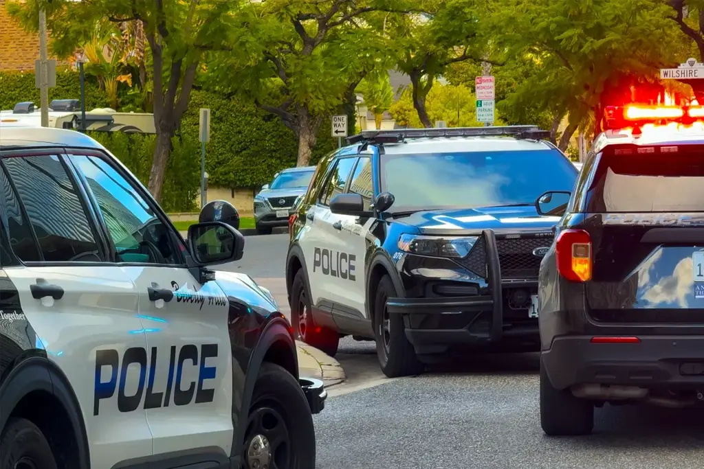 Beverly Hills police vehicles block traffic near Wilshire Boulevard as officers respond to a major incident in the area.