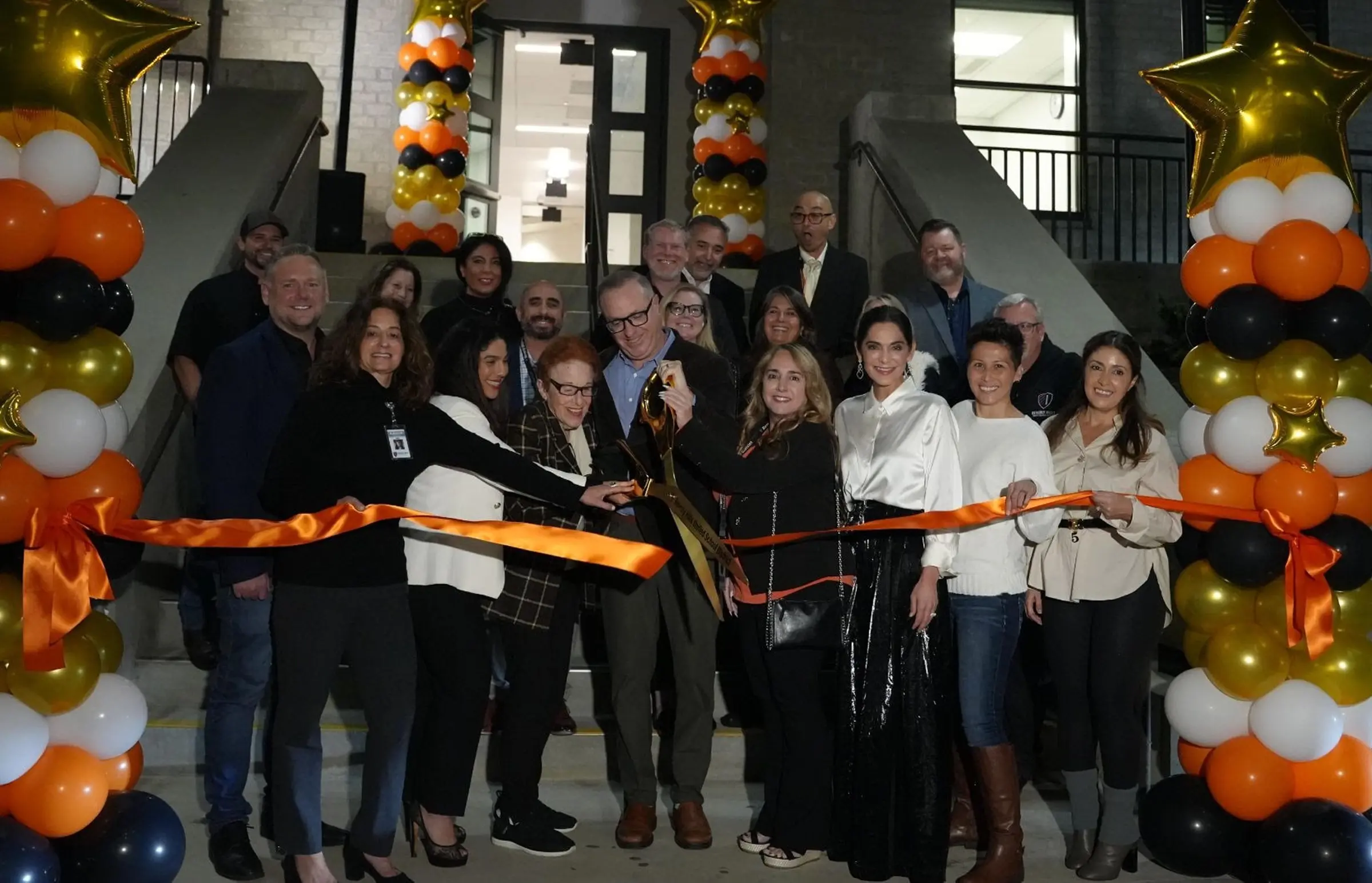 District leaders, school staff, and community members mark the reopening of the Salter Family Theatre during a ribbon-cutting ceremony