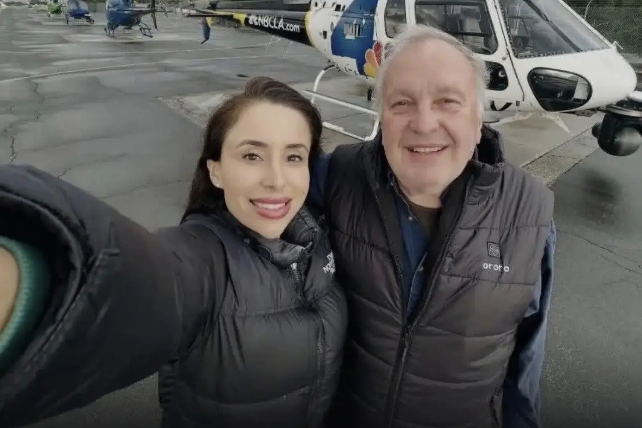 Eliana Moreno and George Marciniw smiling together beside an NBC4 news helicopter.