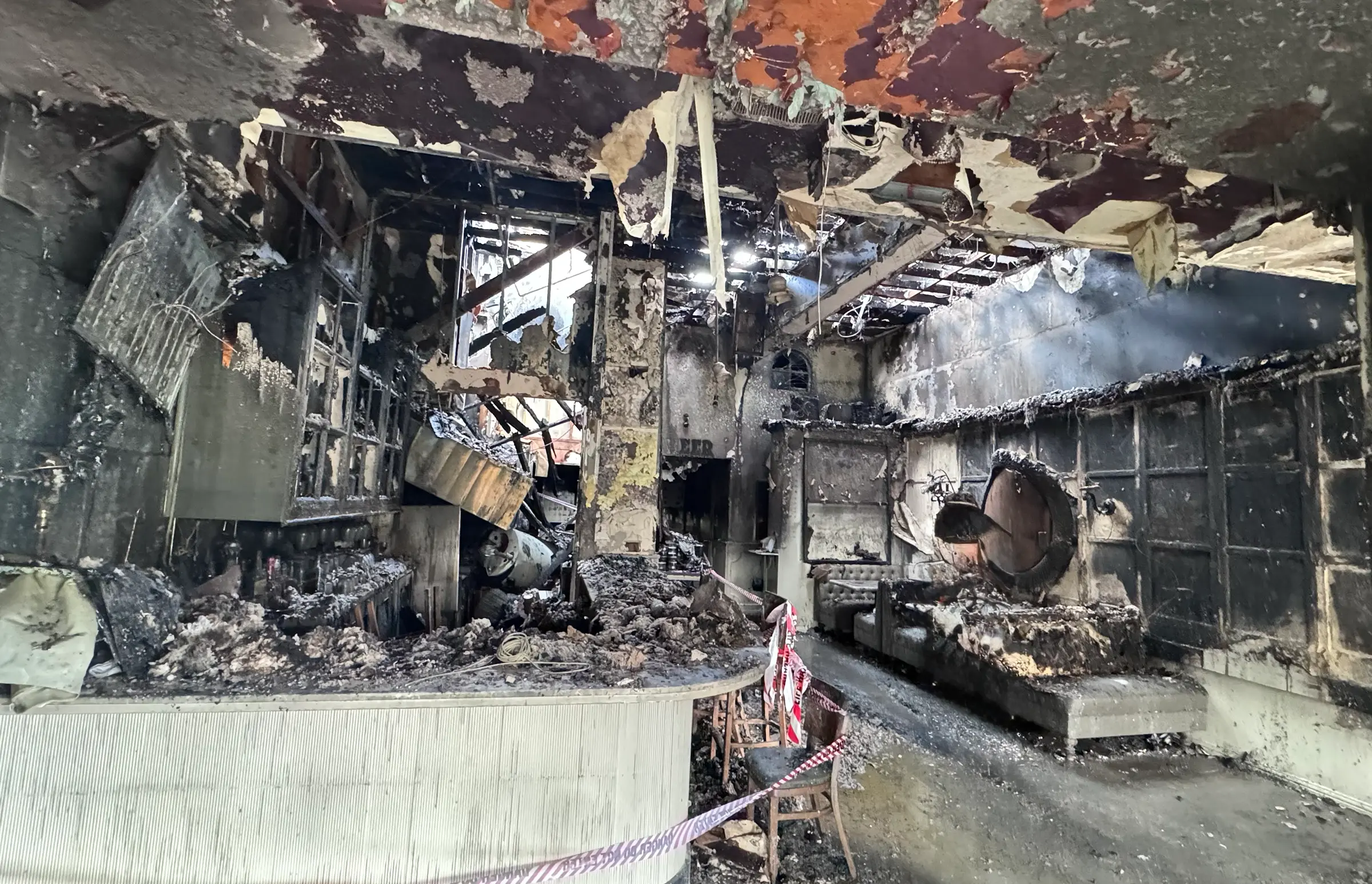 Fire-damaged interior of Porta Via in Beverly Hills after a Christmas morning blaze, showing extensive structural and interior destruction