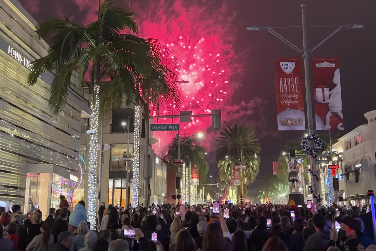 Fireworks light up the sky above Rodeo Drive as crowds gather for the Beverly Hills holiday lighting celebration.
