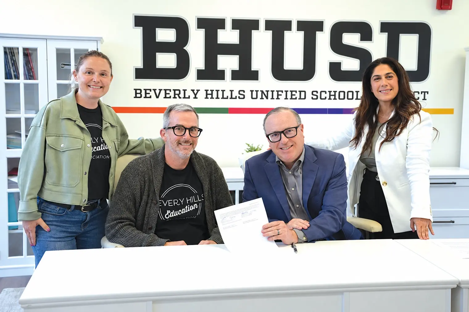From left, BHEA President Katherine Warren, Bargaining Chair Joshua Glass, Superintendent Alex Cherniss and Board President Judy Manouchehri mark the tentative 2026-27 teachers agreement announced May 6.