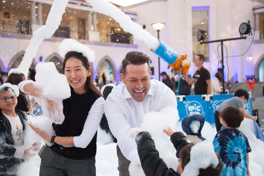 Principal Dr. Steven Suttle and Assistant Principal Adrienne Kim join students in the snow zone during Horace Mann’s Winter Wonderland, a joyful evening of community, creativity, and celebration.