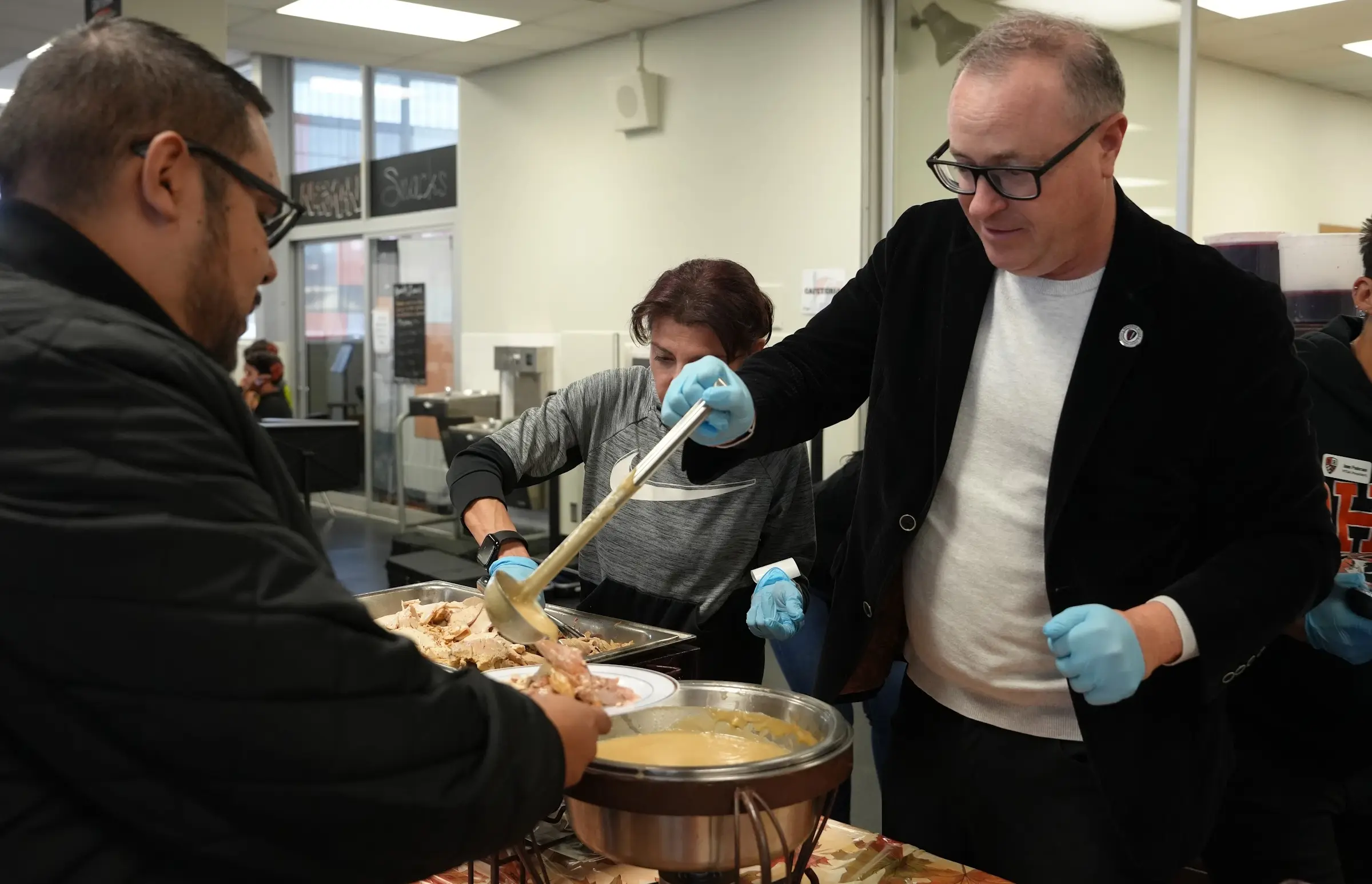 Staff are served lunch by Superintendent Dr. Alex Cherniss at the annual BHHS Thanksgiving luncheon