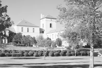 The Grand Lawn at Beverly Hills High School, seen here in the mid-1950s, with the campus watchtower rising behind the front campus landscape.