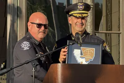 La Verne Police Chief Sam Gonzalez presents Beverly Hills Police Chief Max Subin with a plaque welcoming him to the Los Angeles County Police Chiefs Association.